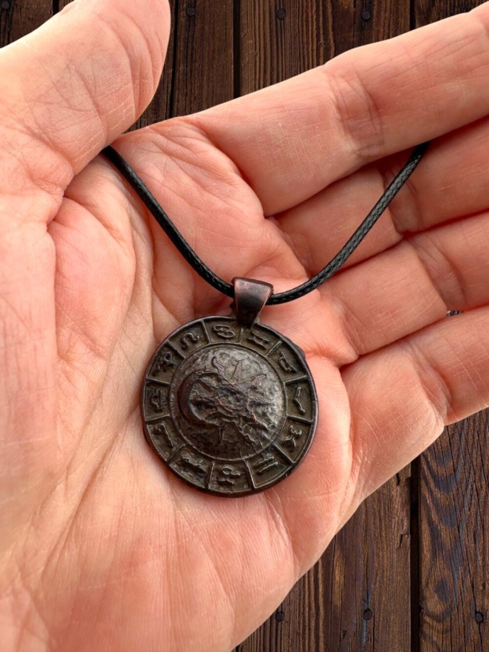 bronze Greek zodiac medallion on black cord